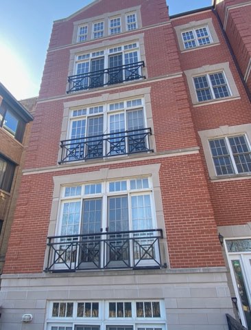 Restored red brick and limestone Chicago townhome facade